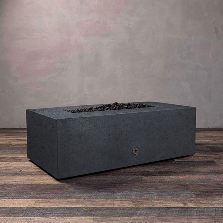 A side view of the Starfire Designs Gravity 48" x 32" Rectangle Rustic Gravity Concrete (GFRC) Fire Pit - Propane Gas Hardline - Graphite with flames on, featuring sleek modern concrete bowl design and durable construction, perfect for outdoor patio spaces. Natural gas or propane compatible, enhancing warmth and ambiance. Lava rocks included for added aesthetic.
