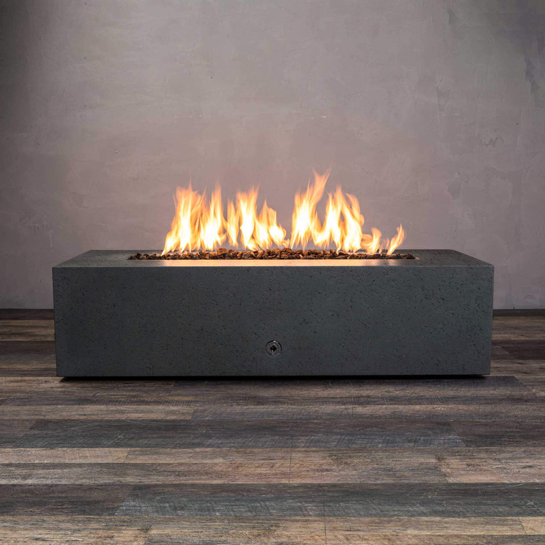 Front view of Starfire Designs Gravity 60" x 32" Rectangle Rustic Gravity Concrete (GFRC) Fire Pit - Propane Gas Hardline - Graphite with flames on, featuring sleek modern concrete bowl design and durable construction, perfect for outdoor patio spaces. Natural gas or propane compatible, enhancing warmth and ambiance. Lava rocks included for added aesthetic.
