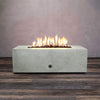 Front view of Starfire Designs Gravity 48" x 32" Rectangle Rustic Gravity Concrete (GFRC) Fire Pit - Propane Gas Hardline - Natural Gray with flames on, featuring sleek modern concrete bowl design and durable construction, perfect for outdoor patio spaces. Natural gas or propane compatible, enhancing warmth and ambiance. Lava rocks included for added aesthetic.
