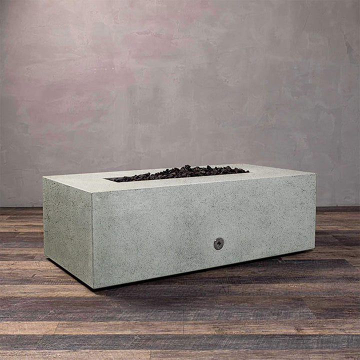 A side view of the Starfire Designs Gravity 48" x 32" Rectangle Rustic Gravity Concrete (GFRC) Fire Pit - Propane Gas Hardline - Natural Gray with flames on, featuring sleek modern concrete bowl design and durable construction, perfect for outdoor patio spaces. Natural gas or propane compatible, enhancing warmth and ambiance. Lava rocks included for added aesthetic.
