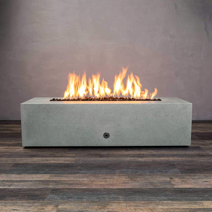 Front view of Starfire Designs Gravity 60" x 32" Rectangle Rustic Gravity Concrete (GFRC) Fire Pit - Propane Gas Hardline - Natural Gray with flames on, featuring sleek modern concrete bowl design and durable construction, perfect for outdoor patio spaces. Natural gas or propane compatible, enhancing warmth and ambiance. Lava rocks included for added aesthetic.
