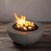 A side view of the Starfire Designs Gravity 36" Round Rustic Gravity Concrete (GFRC) Fire Pit - Propane Gas Hardline - Brown with flames on, featuring sleek modern concrete bowl design and durable construction, perfect for outdoor patio spaces. Natural gas or propane compatible, enhancing warmth and ambiance. Lava rocks included for added aesthetic.
