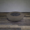 A side view of the Starfire Designs Gravity 45" Round Rustic Gravity Concrete (GFRC) Fire Pit - Propane Gas Hardline - Brown with flames on, featuring sleek modern concrete bowl design and durable construction, perfect for outdoor patio spaces. Natural gas or propane compatible, enhancing warmth and ambiance. Lava rocks included for added aesthetic.

