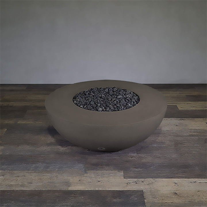 A side view of the Starfire Designs Gravity 45" Round Rustic Gravity Concrete (GFRC) Fire Pit - Propane Gas Hardline - Brown with flames on, featuring sleek modern concrete bowl design and durable construction, perfect for outdoor patio spaces. Natural gas or propane compatible, enhancing warmth and ambiance. Lava rocks included for added aesthetic.
