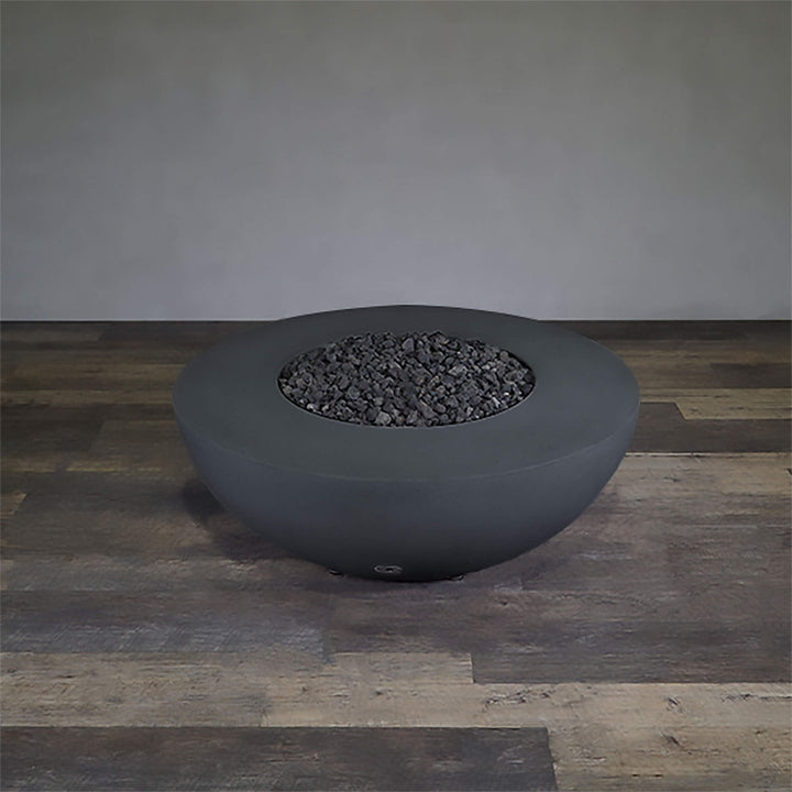 A side view of the Starfire Designs Gravity 45" Round Rustic Gravity Concrete (GFRC) Fire Pit - Propane Gas Hardline - Graphite with flames on, featuring sleek modern concrete bowl design and durable construction, perfect for outdoor patio spaces. Natural gas or propane compatible, enhancing warmth and ambiance. Lava rocks included for added aesthetic.
