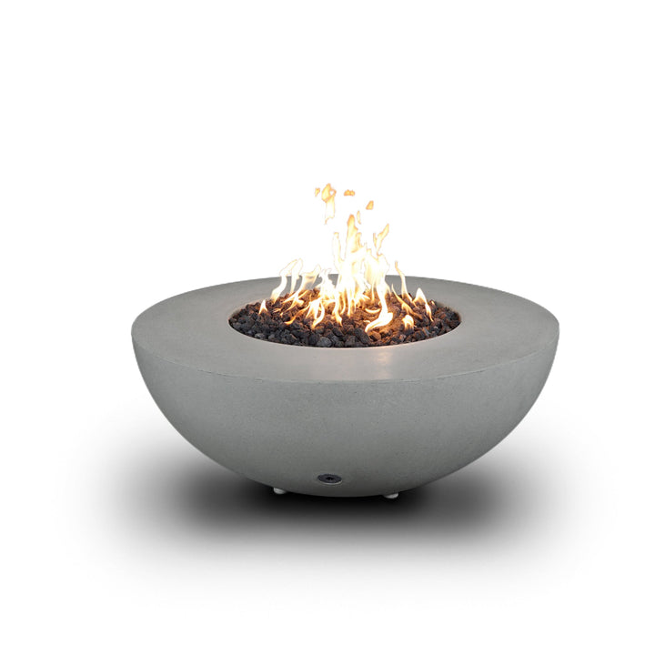 A side view of the Starfire Designs Gravity 45" Round Rustic Gravity Concrete (GFRC) Fire Pit - Propane Gas Hardline - Natural Gray with flames on, featuring sleek modern concrete bowl design and durable construction, perfect for outdoor patio spaces. Natural gas or propane compatible, enhancing warmth and ambiance. Lava rocks included for added aesthetic.
