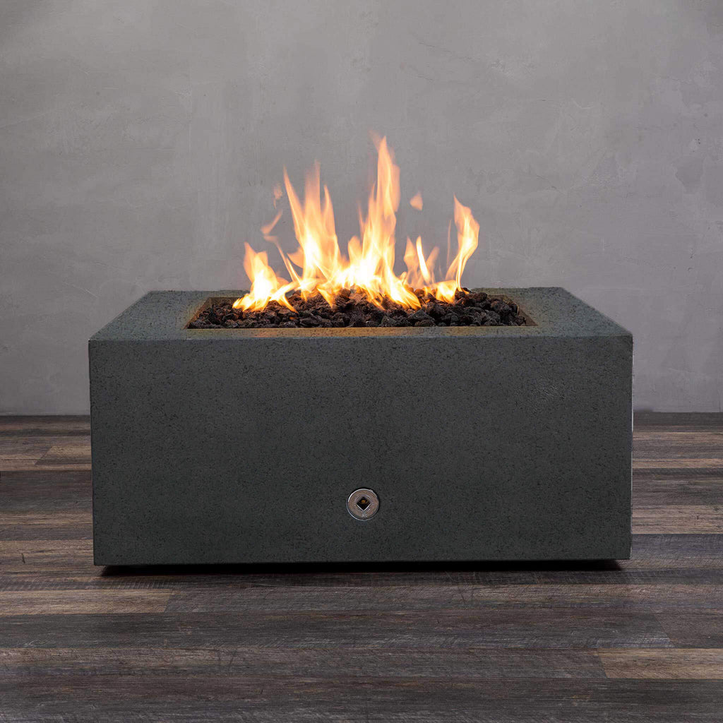 Front view of Starfire Designs Gravity 36" Square Rustic Gravity Concrete (GFRC) Fire Pit - Propane Gas Hardline - Graphite with flames on, featuring sleek modern concrete bowl design and durable construction, perfect for outdoor patio spaces. Natural gas or propane compatible, enhancing warmth and ambiance. Lava rocks included for added aesthetic.
