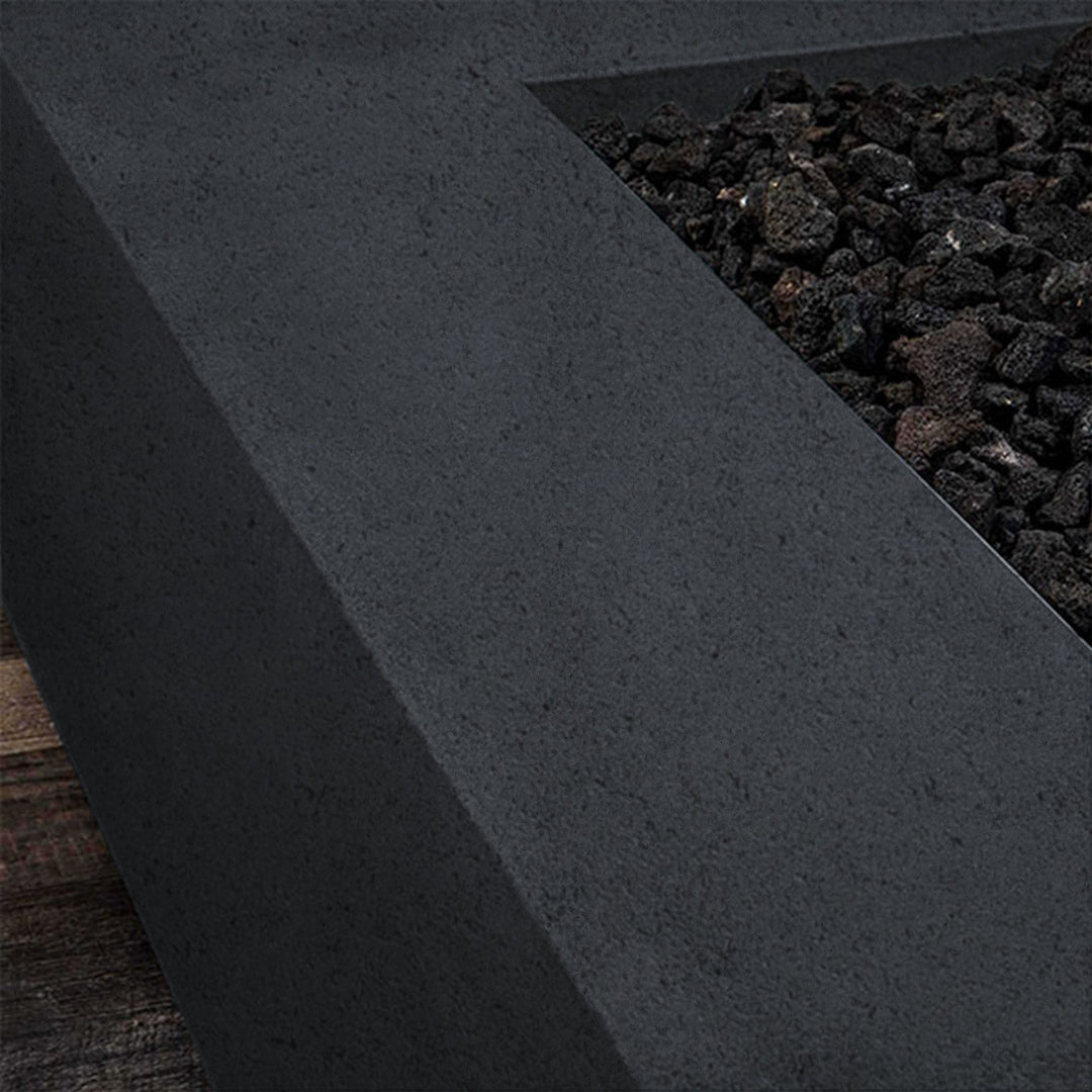 A side view of the Starfire Designs Gravity 36" Square Rustic Gravity Concrete (GFRC) Fire Pit - Natural Gas - Graphite with flames on, featuring sleek modern concrete bowl design and durable construction, perfect for outdoor patio spaces. Natural gas or propane compatible, enhancing warmth and ambiance. Lava rocks included for added aesthetic.
