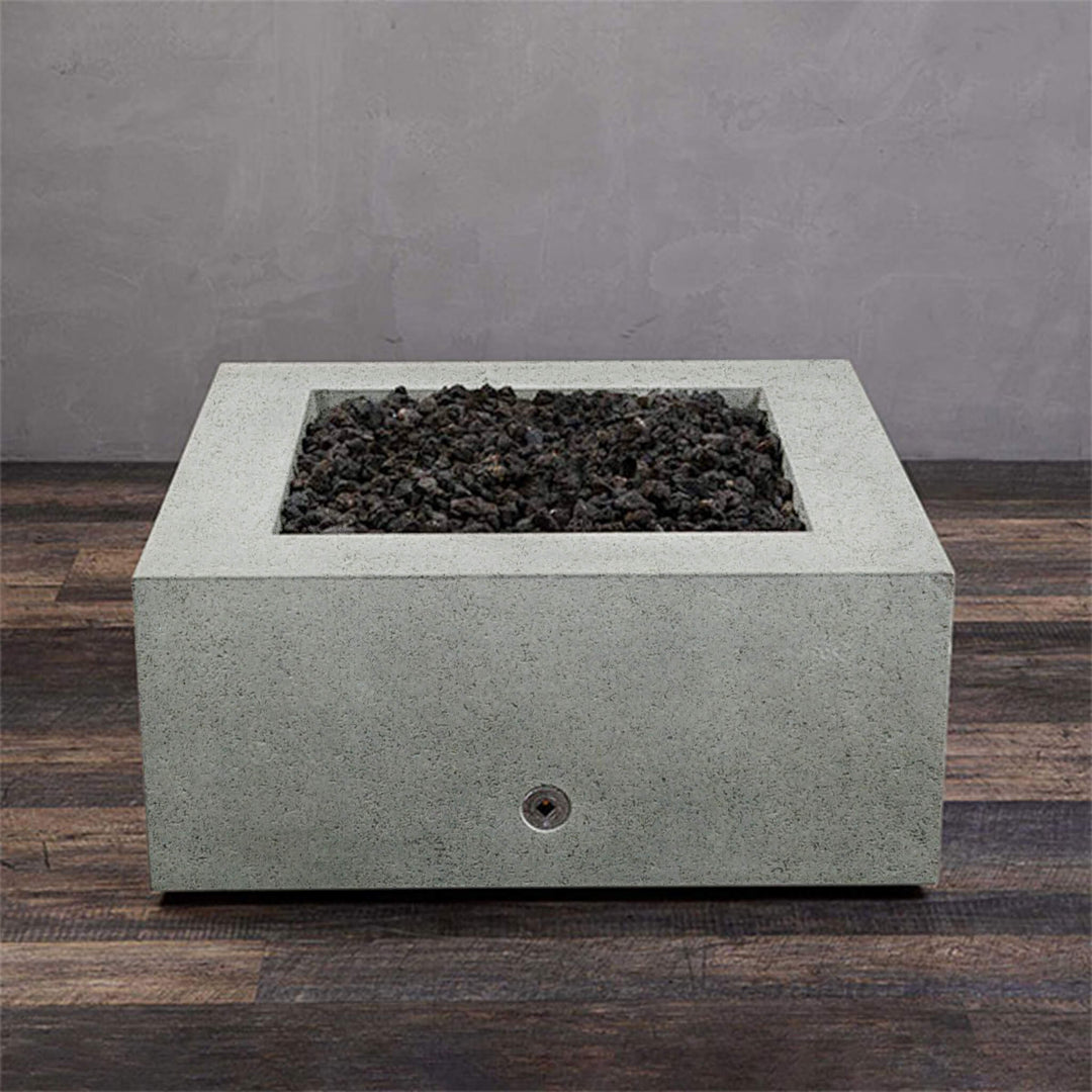 A side view of the Starfire Designs Gravity 36" Square Rustic Gravity Concrete (GFRC) Fire Pit - Propane Gas Hardline - Natural Gray with flames on, featuring sleek modern concrete bowl design and durable construction, perfect for outdoor patio spaces. Natural gas or propane compatible, enhancing warmth and ambiance. Lava rocks included for added aesthetic.
