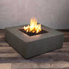 A side view of the Starfire Designs Gravity 45" Square Rustic Gravity Concrete (GFRC) Fire Pit - Propane Gas Hardline - Brown with flames on, featuring sleek modern concrete bowl design and durable construction, perfect for outdoor patio spaces. Natural gas or propane compatible, enhancing warmth and ambiance. Lava rocks included for added aesthetic.
