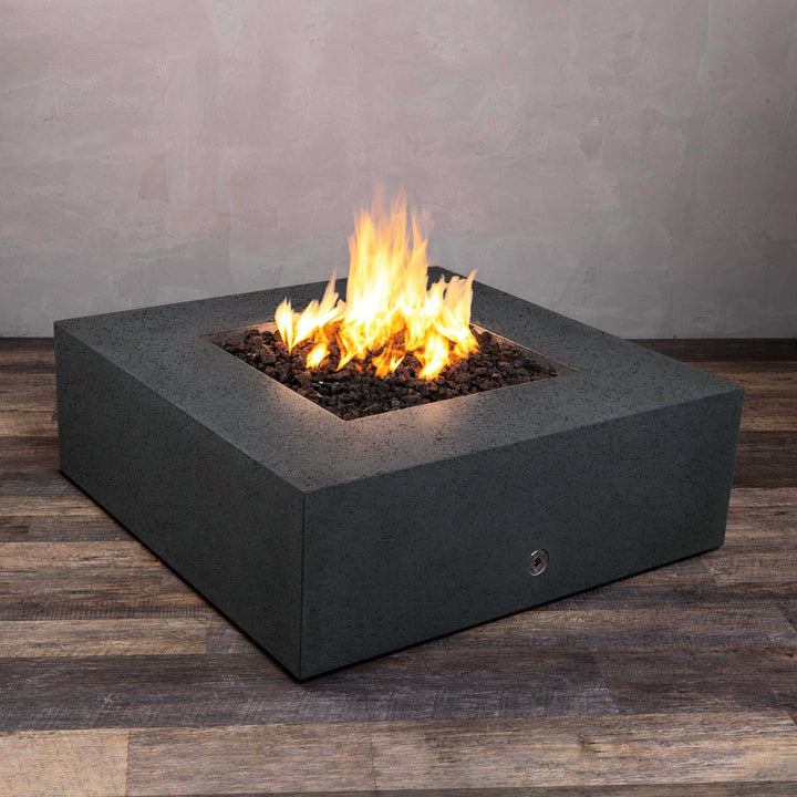 A side view of the Starfire Designs Gravity 45" Square Rustic Gravity Concrete (GFRC) Fire Pit - Propane Gas Hardline - Graphite with flames on, featuring sleek modern concrete bowl design and durable construction, perfect for outdoor patio spaces. Natural gas or propane compatible, enhancing warmth and ambiance. Lava rocks included for added aesthetic.
