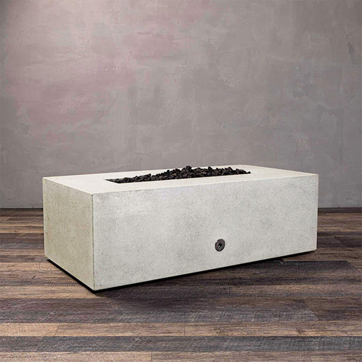 A side view of the Starfire Designs Gravity 48" x 32" Rectangle Rustic Gravity Concrete (GFRC) Fire Pit - Propane Gas Hardline - White with flames on, featuring sleek modern concrete bowl design and durable construction, perfect for outdoor patio spaces. Natural gas or propane compatible, enhancing warmth and ambiance. Lava rocks included for added aesthetic.
