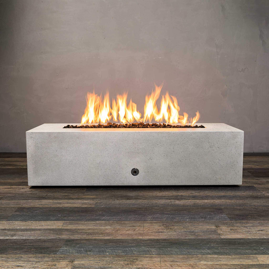Front view of Starfire Designs Gravity 60" x 32" Rectangle Rustic Gravity Concrete (GFRC) Fire Pit - Propane Gas Hardline - White with flames on, featuring sleek modern concrete bowl design and durable construction, perfect for outdoor patio spaces. Natural gas or propane compatible, enhancing warmth and ambiance. Lava rocks included for added aesthetic.
