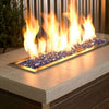 Modern linear fire feature showcasing American Fire Products 1/4" Cobalt Reflective Fire Glass, with vibrant blue tones sparkling beneath bold, golden flames—adding dynamic contrast and bold elegance to any outdoor space.