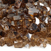 Close-up of American Fire Products 1/4" Copper Reflective Fire Glass, showcasing its rich amber hues, sparkling mirrored edges, and textured facets—ideal for adding a warm, luminous glow to any modern fire feature.