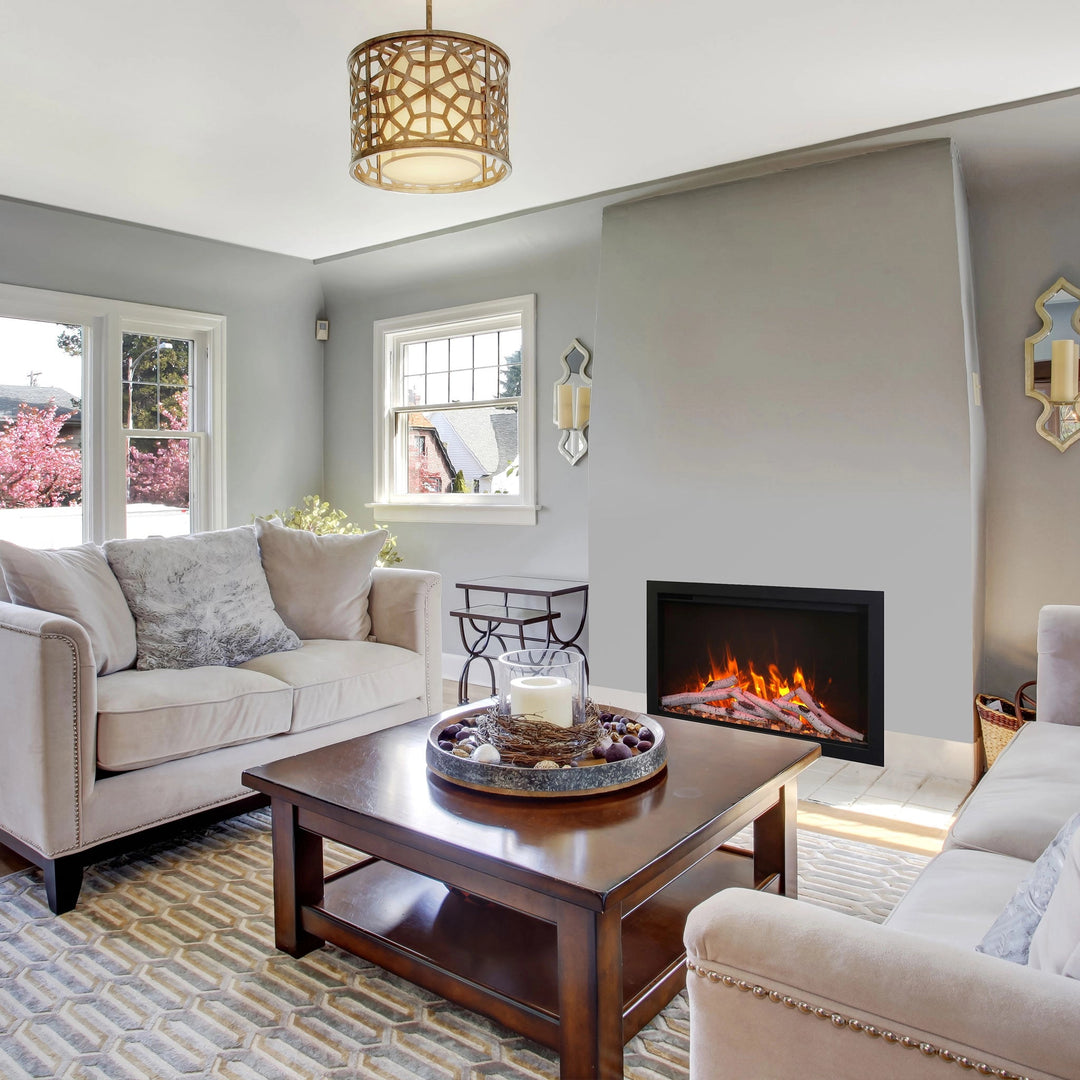 A cozy living room featuring the Amantii Traditional Bespoke Smart Electric Fireplace seamlessly integrated into a gray wall. Surrounded by plush furniture, this energy-efficient fireplace provides both warmth and style, complementing contemporary decor.