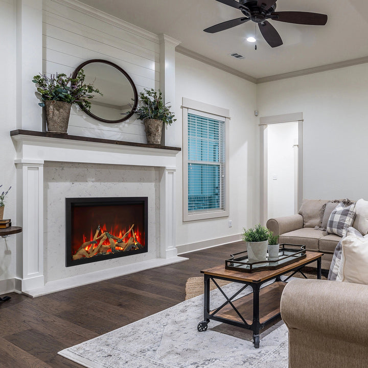 The Amantii Traditional Bespoke Smart Electric Fireplace set within a rustic fireplace mantle in a farmhouse-style living room. With natural wood accents and vibrant flames, it delivers an authentic aesthetic and modern heating convenience.
