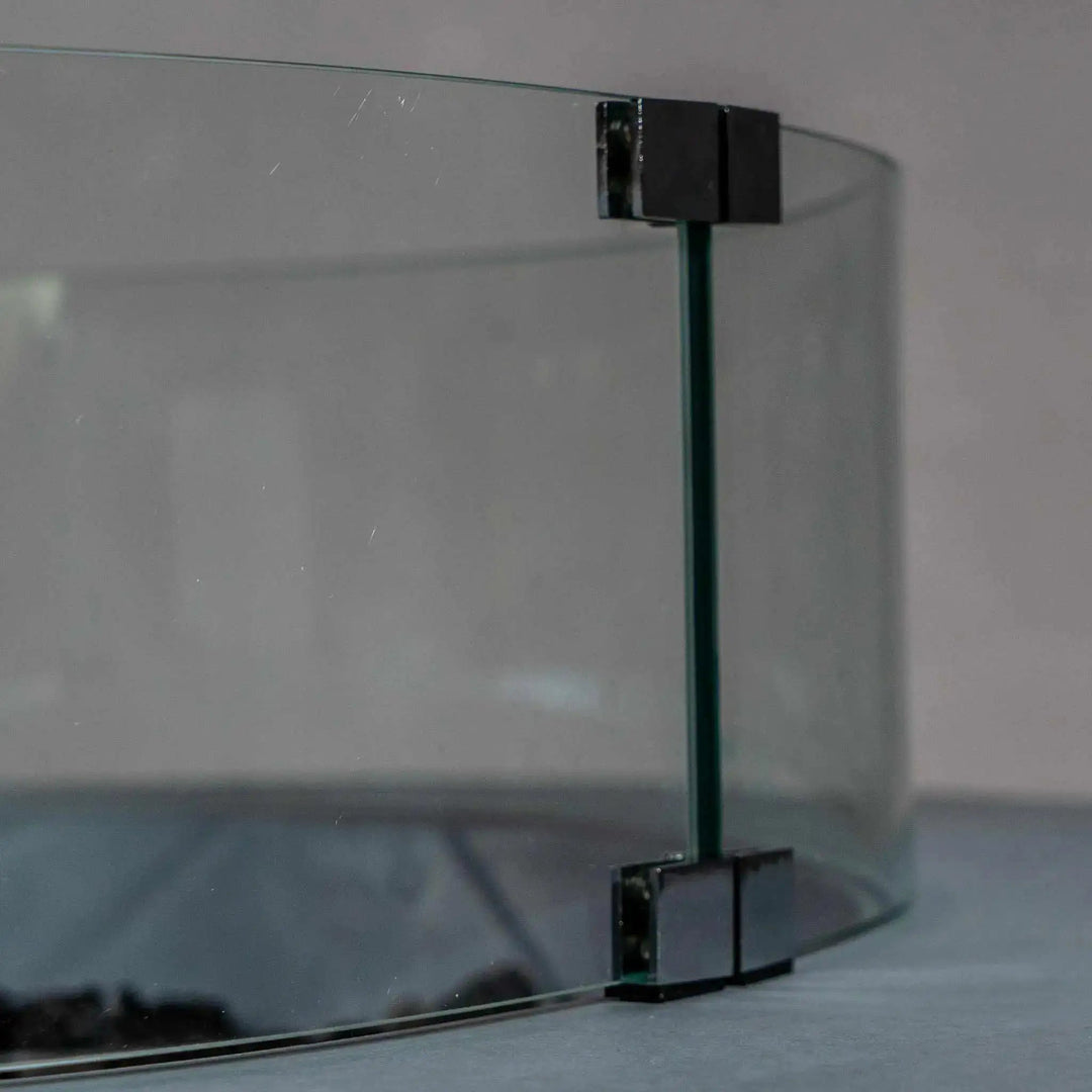 Closeup view of the Starfire Designs Beton Round Glass Wind Guard corner bracket, showcasing the sleek design and secure glass connection