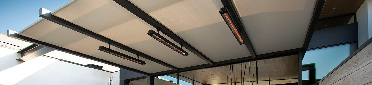 Modern outdoor pergola featuring integrated ceiling infrared heaters, providing warmth and comfort for outdoor spaces, set against a clear blue sky.