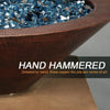 Close-up of the hand-hammered copper finish on the Cono Moreno 31-inch Round Copper Fire and Water Bowl by Starfire Designs, highlighting the intricate craftsmanship and vibrant blue fire glass, perfect for luxury outdoor fire pits