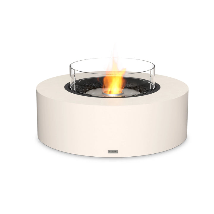 EcoSmart Fire Ark 40 in bone finish featuring a stainless steel burner and glass wind guard, creating a high-end fire pit experience. The modern outdoor gas fire pit boasts a durable concrete base, while the stainless steel burner ensures long-lasting performance. Designed for luxury patio spaces, backyard fire pit areas, and commercial outdoor settings, this model offers clean-burning warmth with a sophisticated aesthetic.