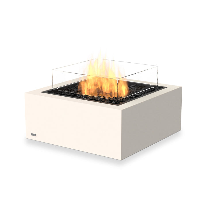 The EcoSmart Fire Base 30 Bone is a propane fire pit table with a glass wind guard, designed for luxury outdoor entertaining. The bone-colored concrete body provides a sleek, contemporary aesthetic, while the wind guard stabilizes the flames, making it ideal for backyards, patios, and commercial settings.

