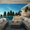 A contemporary outdoor gas fire table setup with the EcoSmart Fire Manhattan 50, positioned beside an infinity pool and surrounded by modern seating. The sleek concrete design and fire bowl outdoor fire pit style make it an elegant addition to luxury fire pits in high-end outdoor spaces, providing warmth and ambiance for stylish evenings.