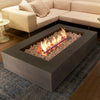 A contemporary indoor living room with a centrally placed EcoSmart Fire Wharf 50, surrounded by a neutral-toned sectional sofa. The concrete fire pit with white fire stones adds a modern yet cozy touch, seamlessly integrating an indoor fire feature with stylish home dÃ©cor.