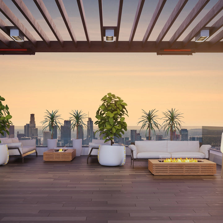 An upscale urban terrace with panoramic city views, featuring two EcoSmart Fire Wharf 50 fire pits in natural teak. Positioned alongside contemporary lounge seating, these luxury fire pits add warmth and elegance, making them an ideal choice for high-end residential or commercial outdoor spaces.