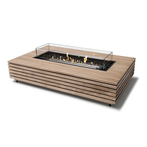 EcoSmart Fire Wharf 50 Teak outdoor fire pit with a black burner and glass wind guard. This modern fire table features a slatted teak wood frame with a sleek rectangular design, offering a stylish and functional fire pit for contemporary outdoor spaces. The natural gas fire pit produces a warm, inviting flame over black fire glass. Perfect for backyard patios, modern decks, and high-end commercial settings.

