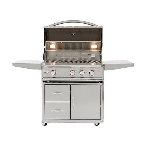 A luxury, stainless steel, portable gas BBQ grill stands on a white background with it's lid open and displaying the burner lights for night-time cooking.