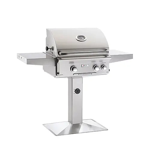 A stainless steel gas BBQ grill is mounted on a custom built mount for commercial sage or for your backyard adn displayed on a white background
