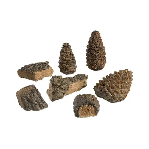 a pile of fireplace decor items such as acorns and chunks of wood are ready to be placed in a fireplace on a white background