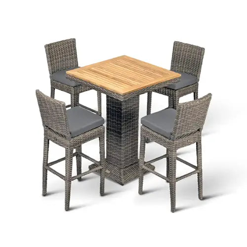 A wicker patio bar set with wooden table top sits ready to dine with guests on a white background