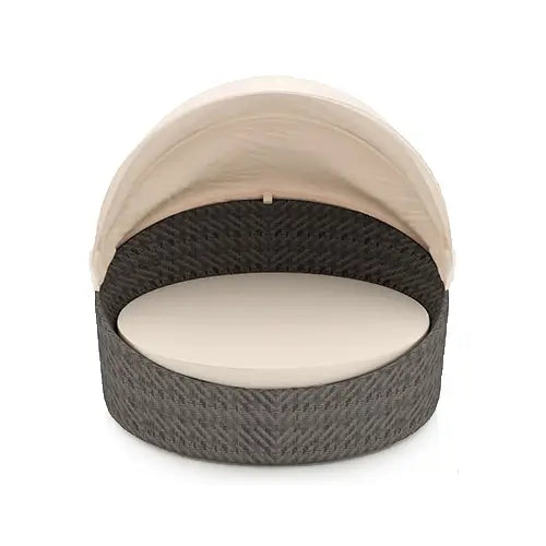 An enormous modern styled Harmonia Living wicker daybed designed for the outdoor patio durability profile is placed on a white background