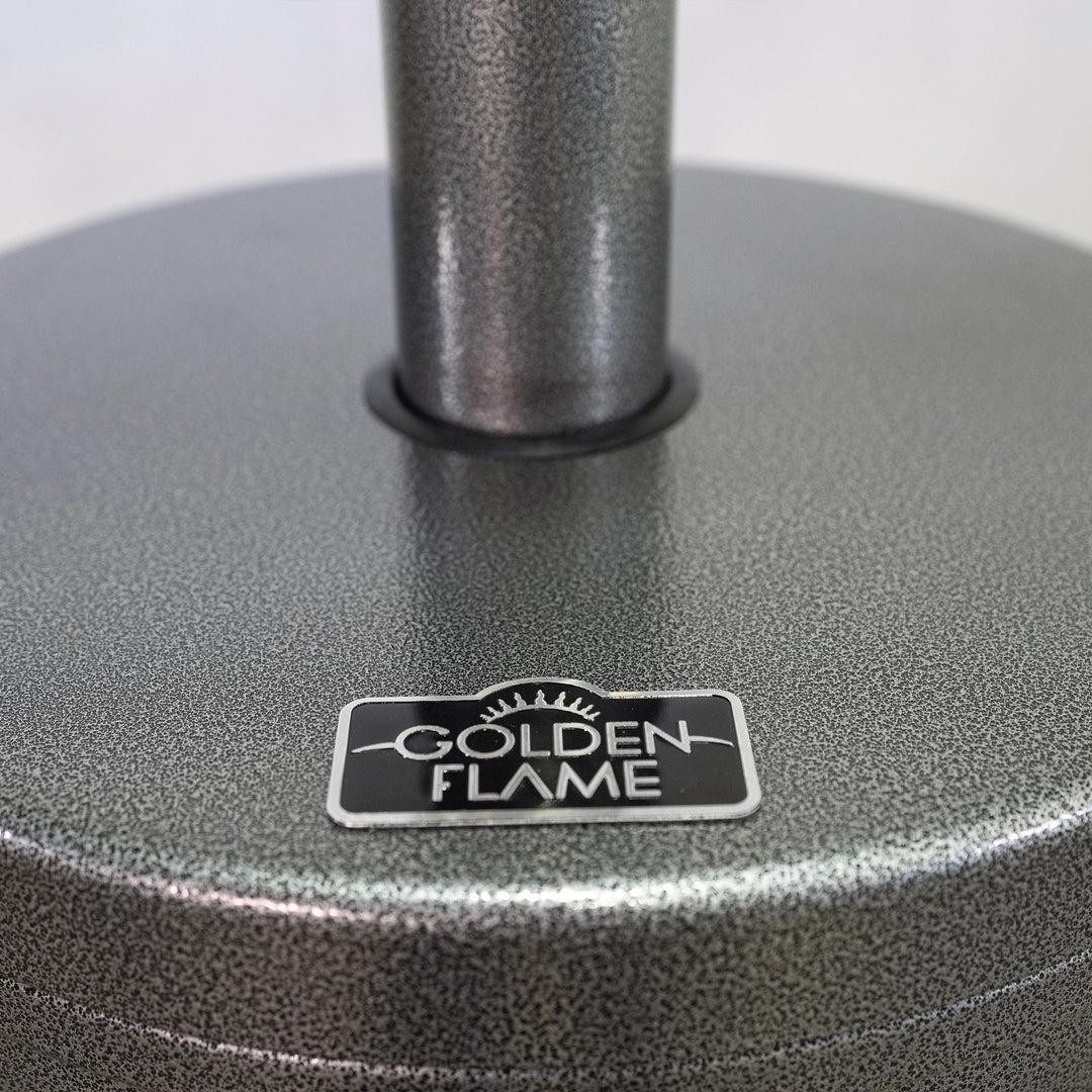 Close-up of the Golden Flame logo on the patio heater in hammered silver finish, focusing on the attention to detail and branding of the product. The image captures the premium quality of the materials and the elegant finish, showcasing the craftsmanship of the Golden Flame heater.