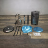 Disassembled view of the Golden Flame Outdoor Natural Gas Patio Heater in a stainless steel finish, featuring all components including the reflector hood, support poles, burner assembly, and protective base. This detailed layout is perfect for showcasing the assembly process and individual parts of the unit.
