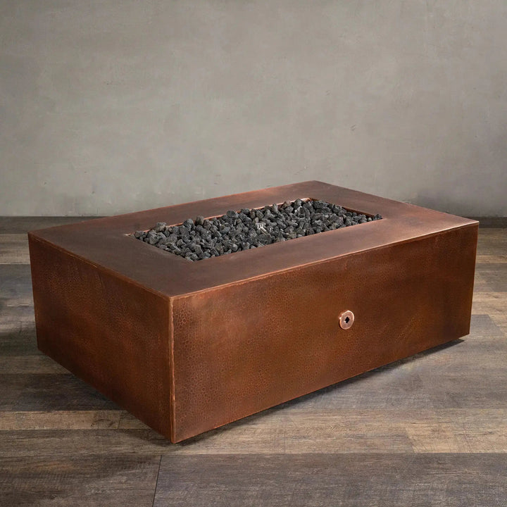 Angled view of Gravity Moreno 48x32 rectangle copper fire pit, highlighting the elegant hammered copper finish and spacious rectangular design, perfect for outdoor gatherings