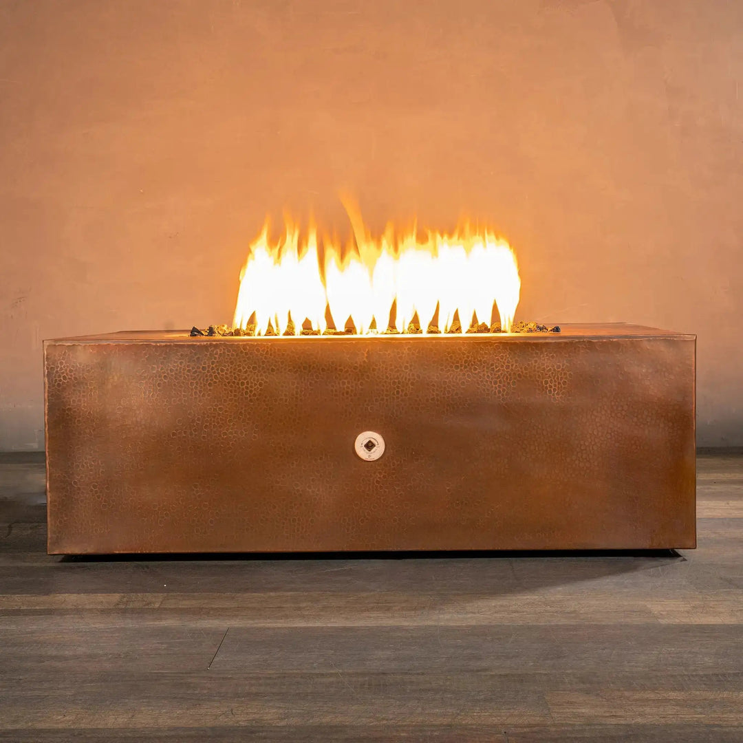 Front view of the Gravity Moreno 48x32 rectangle copper fire pit with a strong flame, featuring a luxurious copper finish and modern design, ideal for outdoor fire pit setups