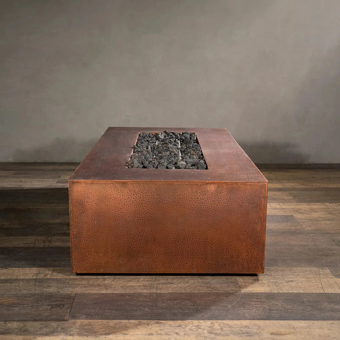 Front view of the Gravity Moreno 60x32 rectangular copper fire pit by Starfire Designs, featuring a handcrafted copper finish with lava rocks, perfect for modern outdoor living spaces