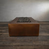 End view of the Gravity Moreno 72x38 copper fire pit by Starfire Designs, highlighting the elongated rectangular shape and rustic copper finish