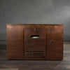 Front view of the Gravity Moreno 72x38 copper fire pit by Starfire Designs, highlighting the hidden propane tank access panel with a hammered copper finish