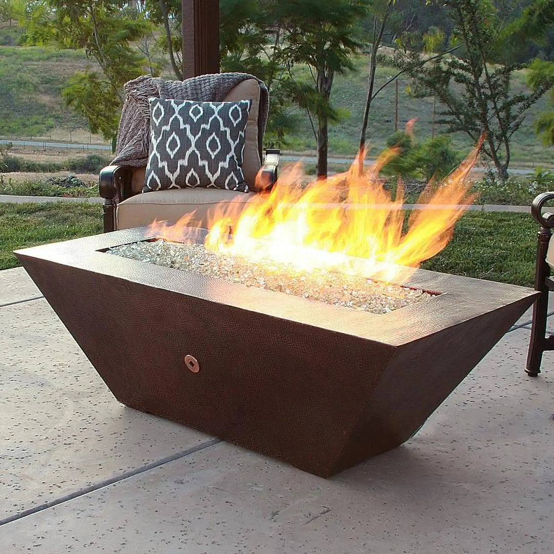 Largo Moreno 60-inch x 26-inch Rectangle Copper Fire Pit by Starfire Designs, elegantly crafted with hand-hammered copper, burning with clear fire glass
