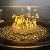 Close-up of the Golden Flame Malibu 44” Round Cast Aluminum Natural Gas Fire Table with golden flames reflecting off clear glass fire beads. Features a sleek circular design, highlighting the vibrant fire display.