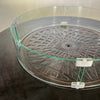  Detailed close-up of the Golden Flame Malibu 44” Round Cast Aluminum Natural Gas Fire Table's glass wind guard, showcasing its durability and high-quality metal clips.