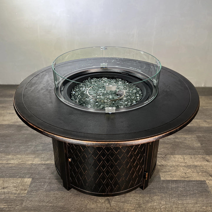 Top view of the Golden Flame Malibu 44” Round Cast Aluminum Natural Gas Fire Table featuring clear glass beads within the burner area and a smooth tabletop finish.