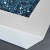 Close-up of the corner of the Mill 40-inch Square Steel Gas Fire Pit in White Hammertone, showcasing the premium blue fire glass. A modern outdoor fire pit designed for luxurious backyard spaces