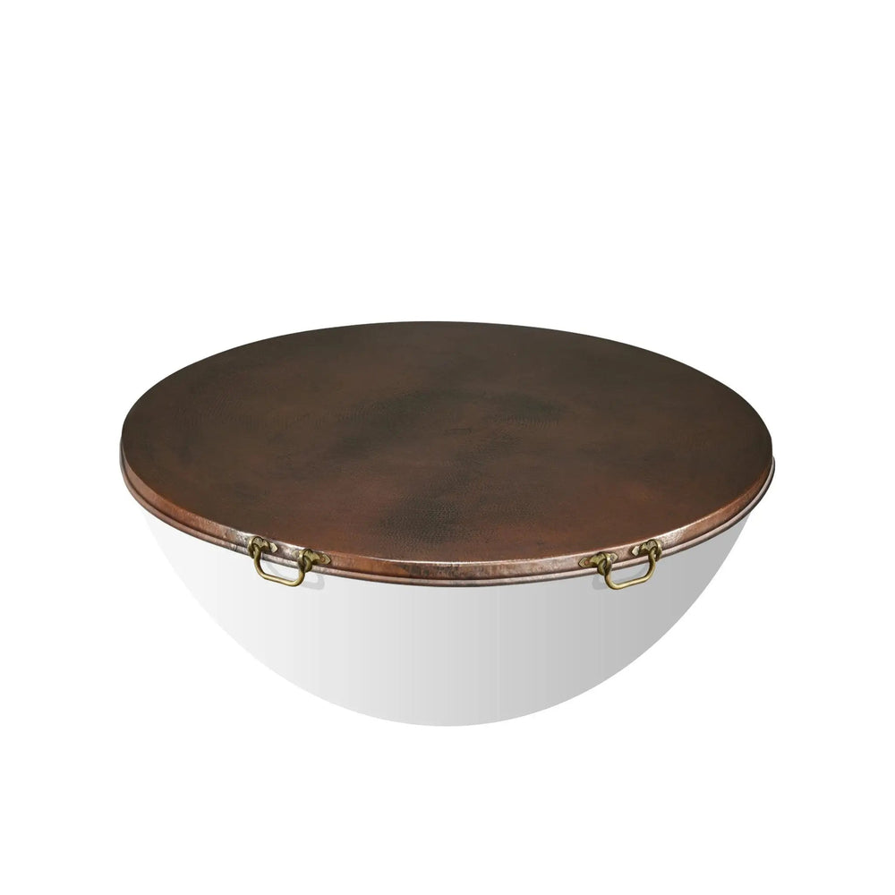 Detailed shot of the brass handle on the Moreno 45-inch round copper fire pit lid. The hand-hammered copper lid with sturdy handles ensures durability and ease of use, making it a functional and attractive addition to any outdoor fire pit. Ideal for round fire pits, copper lids, and fire pit covers with handles