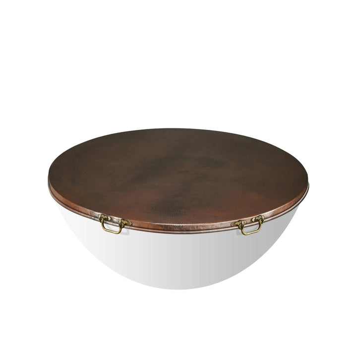 Detailed shot of the brass handle on the Moreno 45-inch round copper fire pit lid. The hand-hammered copper lid with sturdy handles ensures durability and ease of use, making it a functional and attractive addition to any outdoor fire pit. Ideal for round fire pits, copper lids, and fire pit covers with handles