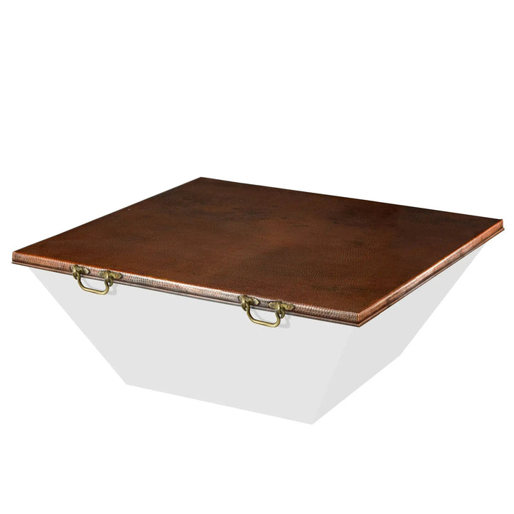 Moreno 50-inch square copper fire pit lid with a beautiful hammered copper finish and brass handles for convenient portability. This sturdy cover provides outdoor protection for square fire pits when not in use. The unique texture and hand-crafted design enhance the overall aesthetic of copper fire pits, making it a stylish and protective accessory for backyard setups